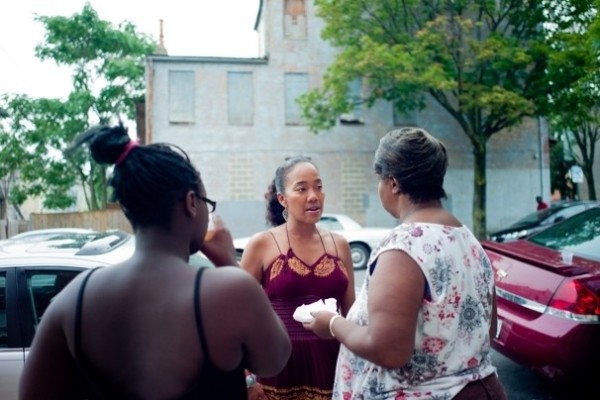 Sohn speaks with community members in Baltimore. Photo courtesy of Hector Emanuel and The Washington Post.