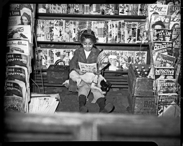 Girl reading comic book in newsstand, c. 1940–1945. Photograph by Charles “Teenie” Harris courtesy of Eyes on Pittsburgh and the Carnegie Museum of Art